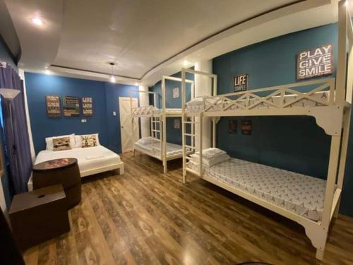 a room with two bunk beds in a room at Country Home Resort in Oslob