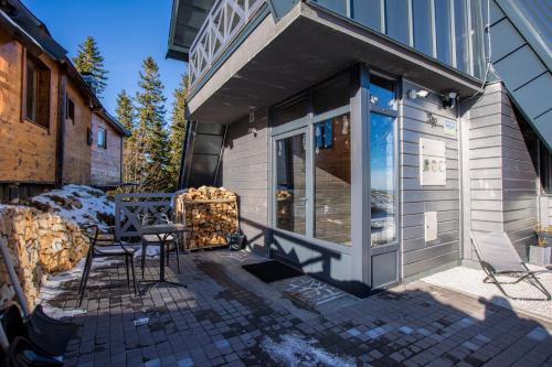 a patio with a table and chairs next to a building at Casa Valley Paradiso - Jahorina in Jahorina