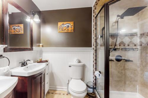 a bathroom with a toilet and a sink and a shower at Camp Unicorns Bigfoot Manor in Marion