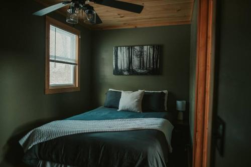 a bedroom with a bed with a ceiling fan at Mountainscape: Peaceful & Skiing in Roxbury