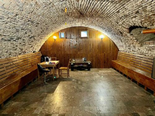 a room with a brick wall and a table and chairs at SIAN Sanctuary Villa in Braşov