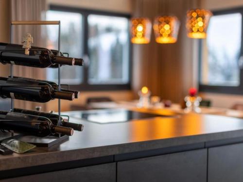 a kitchen with a counter with wine bottles on it at Mountain Hide-Away in Altbach