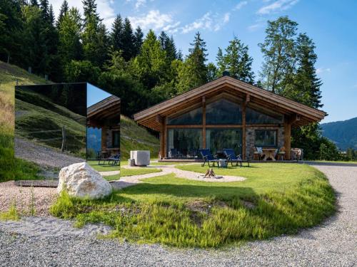 a large log cabin with a large window on a hill at Mountain Hide-Away in Altbach