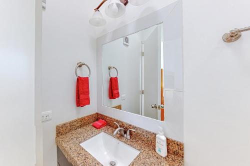 a bathroom with a sink and a mirror at Casa Roble 24 - Playa Arcangel in Rosarito