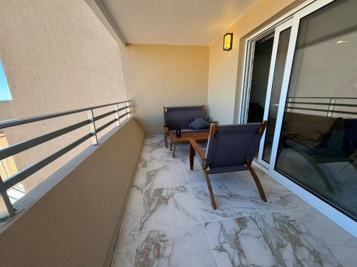 uma varanda com 2 cadeiras e uma mesa na varanda em Vue Mer à Proximité de Monaco em Beausoleil