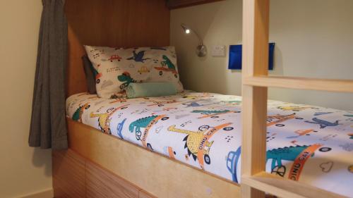 a bedroom with a bunk bed with a wooden bed frame at Adventure Wanaka Hostel in Wanaka