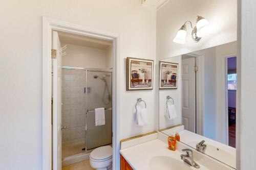 a white bathroom with a sink and a shower at Take a Peak in Incline Village
