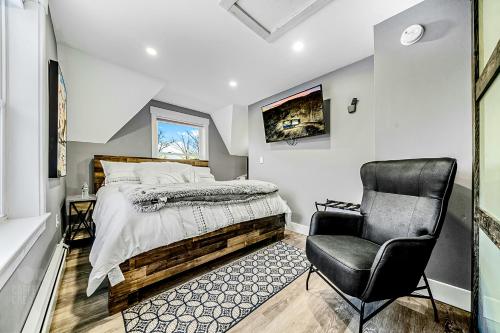 a bedroom with a bed and a chair at Bryant Pond Chalet in Greenwood