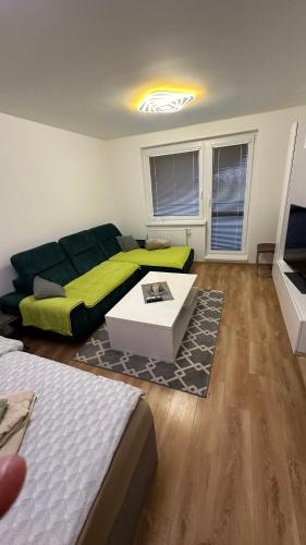 a living room with a bed and a couch at Apartman City Park Stráňany in Michalovce