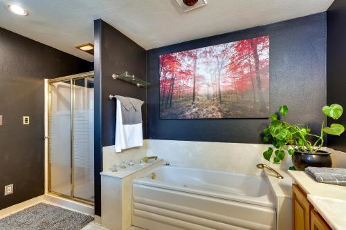 a bathroom with a tub and a painting on the wall at The 9th Green in Colorado Springs