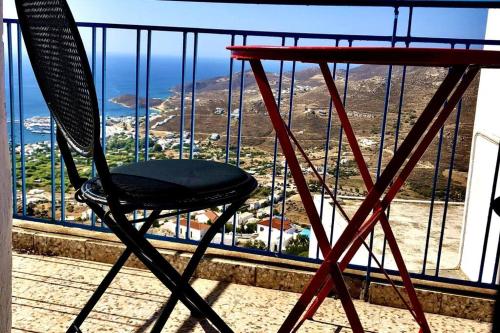 a chair sitting on top of a balcony at School House with Panoramic View in Serifos Chora
