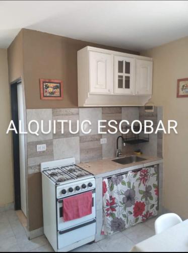 cocina con fogones blancos y fregadero en ALQUITUC ESCOBAR II en Belén de Escobar