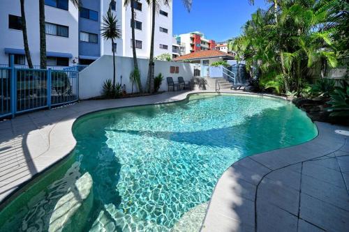 a swimming pool with turquoise water in a building at Paradise at Picnic Point - 3B/R in Maroochydore