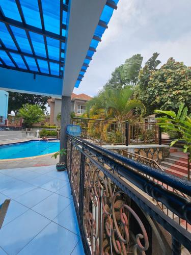 a balcony with a fence and a swimming pool at HILLS APARTMENTS in Kampala