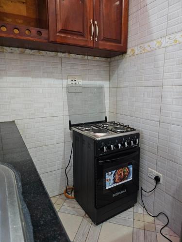 a stove in the corner of a kitchen at HILLS APARTMENTS in Kampala