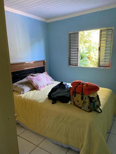 a bedroom with a bed with a backpack on it at Recanto do Bira in Socorro