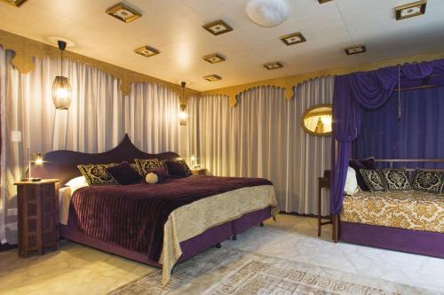 a bedroom with purple curtains and a bed at The Retreat at Froog Moore Park in Tamworth