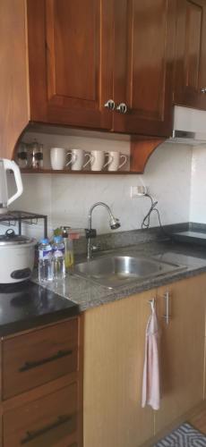 a kitchen with a sink and a counter top at Mesaverte Residences "ZACE STUDIO" in Cagayan de Oro