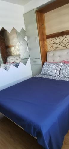 a pair of beds in a room with a mirror at Mesaverte Residences "ZACE STUDIO" in Cagayan de Oro