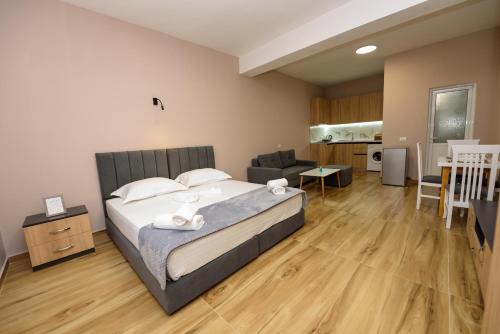 a bedroom with a bed and a living room at Mezani Guest House in Vlorë