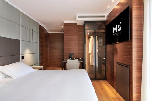 a bedroom with a bed and a sign on the wall at Hotel MyPalace León in León