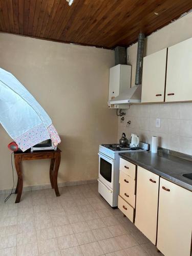 a kitchen with a stove and a table in it at BITTY in Chajarí