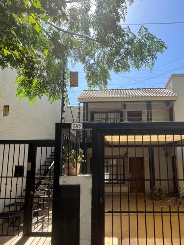 a house with a gate in front of it at Cerca de todo! Ubicación estratégica in Godoy Cruz