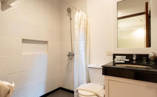 a bathroom with a shower and a toilet and a sink at Le Soleil de Boracay Hotel in Boracay
