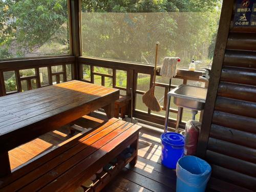 a porch with a wooden bench and a table at Ji Ji Farm Homestay in Jiji