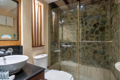 a bathroom with a shower and a toilet and a sink at Le Soleil de Boracay Hotel in Boracay