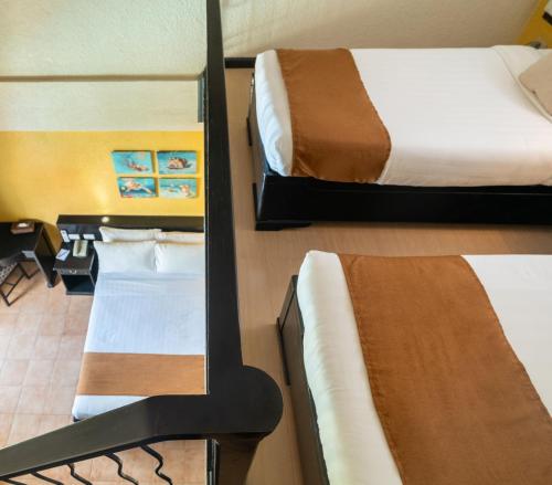 two beds in a room with a mirror at Le Soleil de Boracay Hotel in Boracay