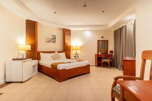 a hotel room with a bed and a desk at Le Soleil de Boracay Hotel in Boracay