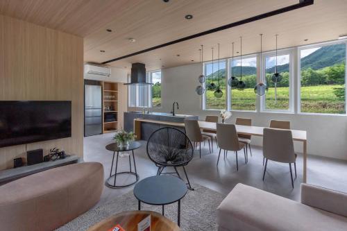 a kitchen and living room with a table and chairs at Japavista Rusutsu in Rusutsu