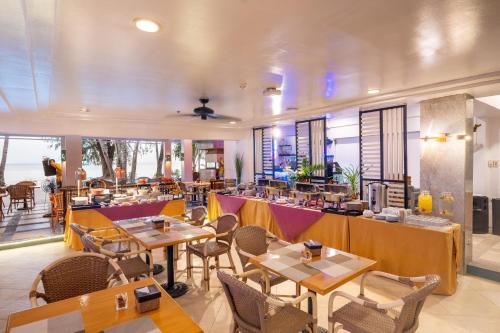 a restaurant with tables and chairs in a room at Le Soleil de Boracay Hotel in Boracay