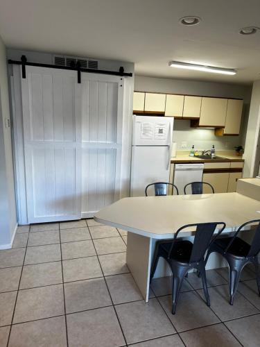 een keuken met een tafel en stoelen en een keuken met een koelkast bij Ocean City, MD Waterfront Villa in Ocean City