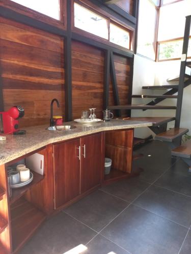 a kitchen with a counter and a sink in a room at Arenal Getaway in Fortuna