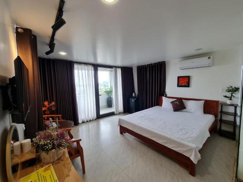 a bedroom with a bed and a television in it at SUN HOTEL in Hue