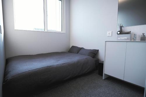 a small bedroom with a bed and a window at NEW HUMBER 