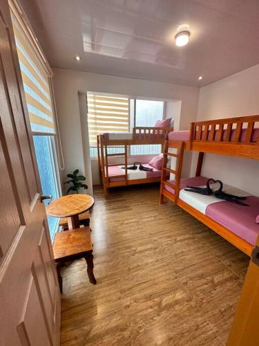 a room with two bunk beds and a table at Yllib Transient Condo in Baguio