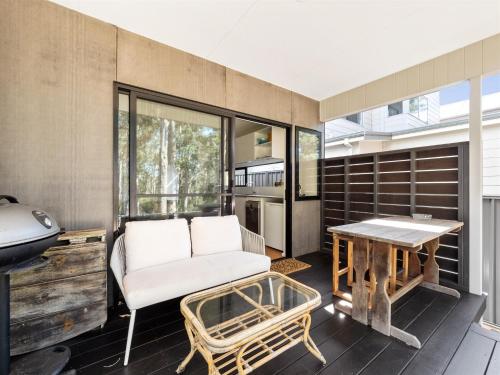 a living room with a couch and a table at Tall Trees Margaret River in Margaret River Town