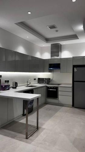 a large kitchen with a counter and a sink at شقة خاصة فاخرة + صالة بلياردو in Riyadh