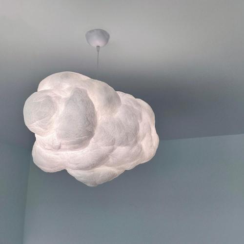 a white light fixture hanging from a ceiling at 虎尾慢遊 in Huwei