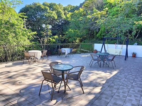 a group of tables and chairs on a patio at Bokelai B&B in Renai