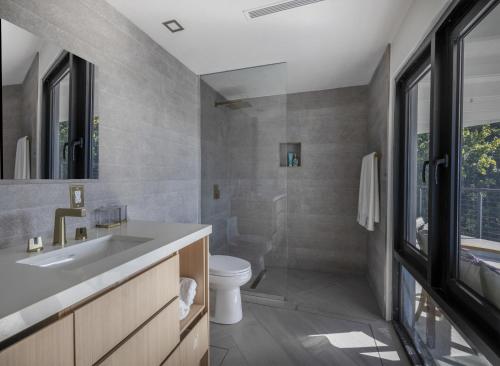 a bathroom with a sink and a toilet at Villa Kia Orana in Cruz Bay