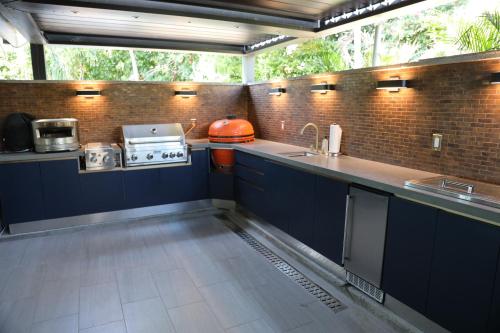 a kitchen with blue cabinets and a counter top at Villa Kia Orana in Cruz Bay