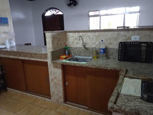 eine Küche mit einer Spüle und einer Theke in der Unterkunft Rancho dos pescadores in Ilha Comprida
