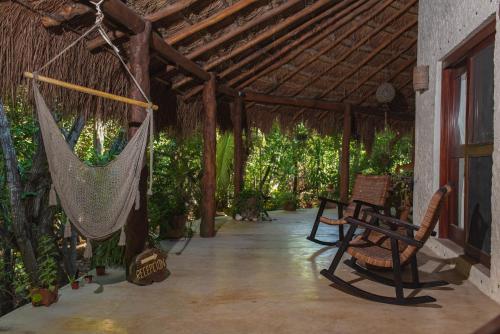 a porch with a hammock in a house at Casa Takywara in Holbox Island