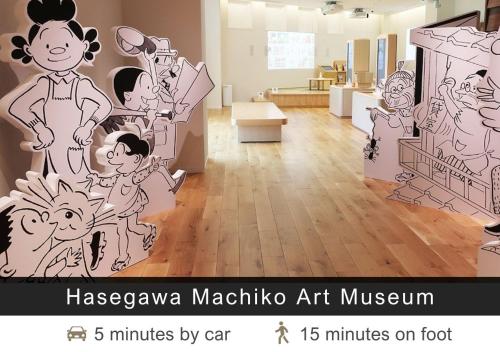 a room with a mural of a group of people at Tokyu Stay Yoga in Tokyo