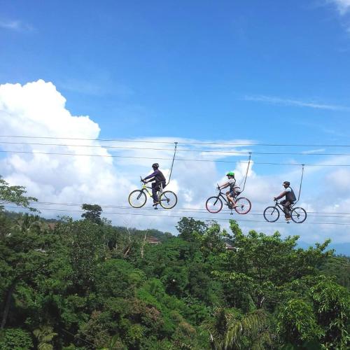 a group of three people riding bikes in the air at Tanawin BnB in Orani