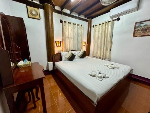 Ένα ή περισσότερα κρεβάτια σε δωμάτιο στο Rattana Guesthouse